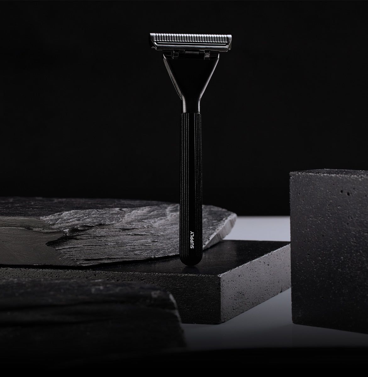 Black safety razor on a dark background