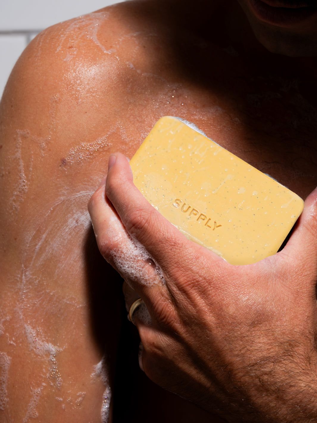 Bar soap in hand in shower use 